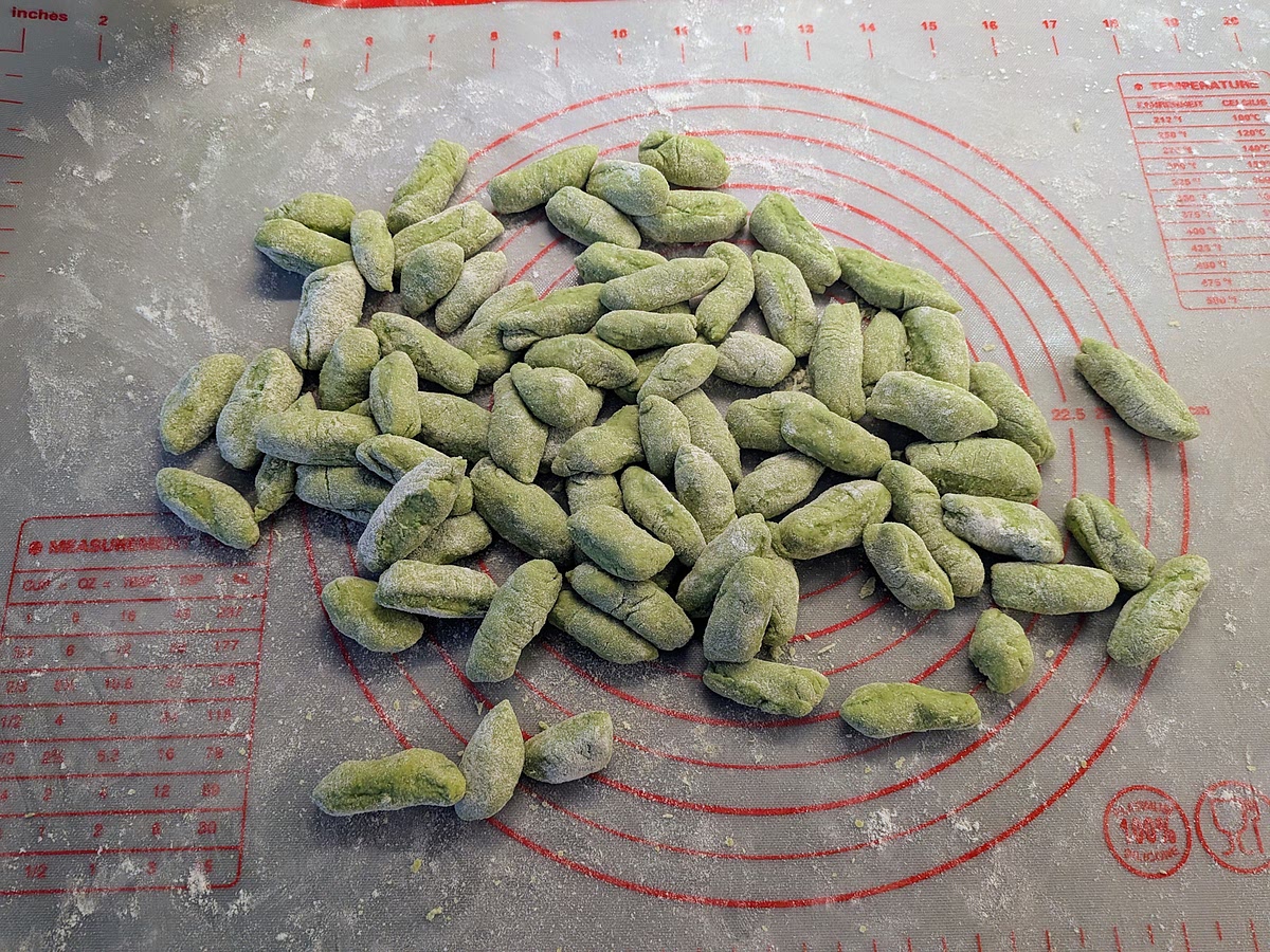 Roll the gnocchi one by one on floured hands so they are coated in flour. this prevents them sticking to each other.