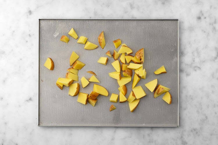Preheat your oven to 240°C/220°C fan/gas mark 9. Chop the potatoes into 3cm chunks (no need to peel). Pop onto a large baking tray. Drizzle with oil, season with salt and pepper, then toss to coat. Spread out in a single layer. TIP: Use two baking trays if necessary. When the oven is hot, roast on the top shelf for 20 mins - you'll roast them for longer once you've crushed them.