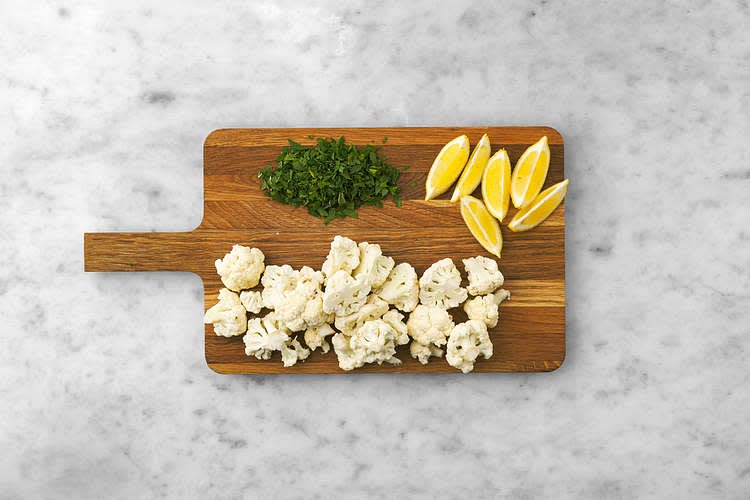 Meanwhile, cut the cauliflower into florets (like small trees), halving any large ones. Cut the lemon into wedges. Drain the sweetcorn in a sieve. Heat a drizzle of oil in a large frying pan on high heat. Once hot, add the sweetcorn and cook until charred, 5-6 mins. Adjust the heat if necessary. Stir only twice during this time - you want the sweetcorn to pick up some nice colour.