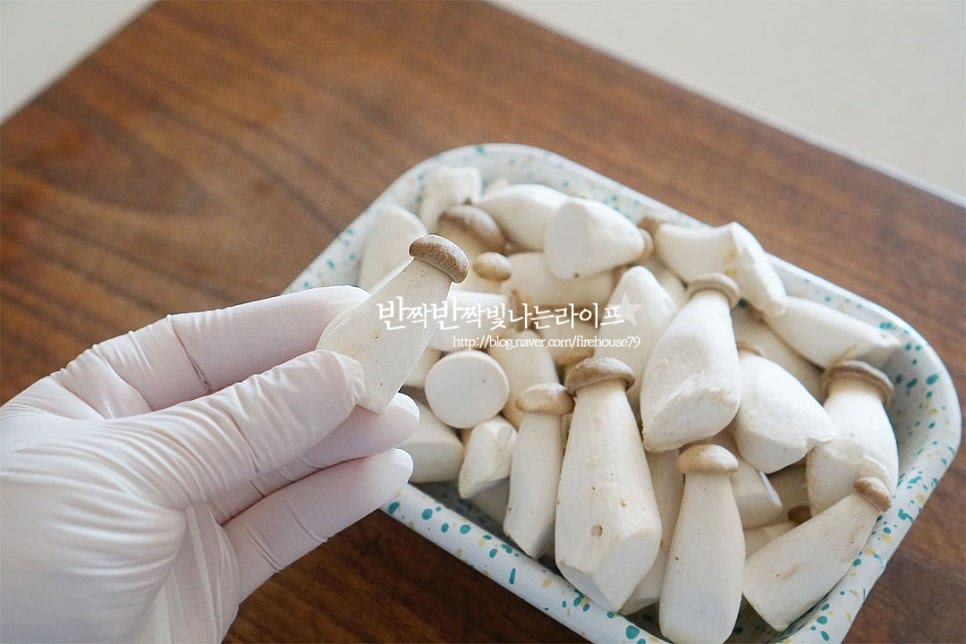 버섯은 수분에 약한 재료이기 때문에 젖은 키친타월로 닦아주거나 흐르는 물에 빠르게 씻어 물기를 제거하여 줍니다. 꼬마 사이즈 같은 경우 밑동을 자르거나 손질할 것이 없어서 요리하기에 더 간편해요. 크기에 따라 작은 것은 그대로, 통통하게 큰 것은 2~3등분 하여 줍니다. 세로방향으로 결대로 썰어주시면 더 식감이 좋아요. 색감과 맛을 더해주는 당근과 쪽파는 길이를 맞추어 썰어주고, 홍고추는 어슷하게 자르고, 통마늘은 향이 풍부하도록 바로 칼등으로 으깨어 주었습니다. 통마늘 대신 다진 마늘도 좋아요.