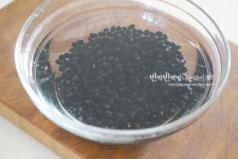 콩은 불리기 전 먼저 가볍게 세척해 줍니다. 세척하면서 깨진 것이나 상태가 좋지 않은 것은 골라내어 주세요. 블랙푸드 중에서도 안토시아닌 성분이 풍부한 콩은 부드러운 콩조림을 만들기 위해 불린 물을 그대로 활용해 줄 것이에요. 종이컵 1컵 기준으로 물 500ml 정도를 부어준 뒤 대략 5~6시간을 불려줍니다. 미리 불린 뒤 요리하면 조리 시간도 단축되고 식어도 부드럽게 맛볼 수 있어요. 묵은 콩이나 건조한 상태에 따라 불리는 시간은 조금 차이가 날 수 있습니다. 물이 붉은색으로 변하고 처음보다 통통하게 불리면 체에 밭쳐 콩과 불린 물을 분리해 줍니다. 불린 물을 같이 넣고 콩자반을 만들면 영양은 물론 맛과 풍미를 더 깊게 만들 수 있답니다.