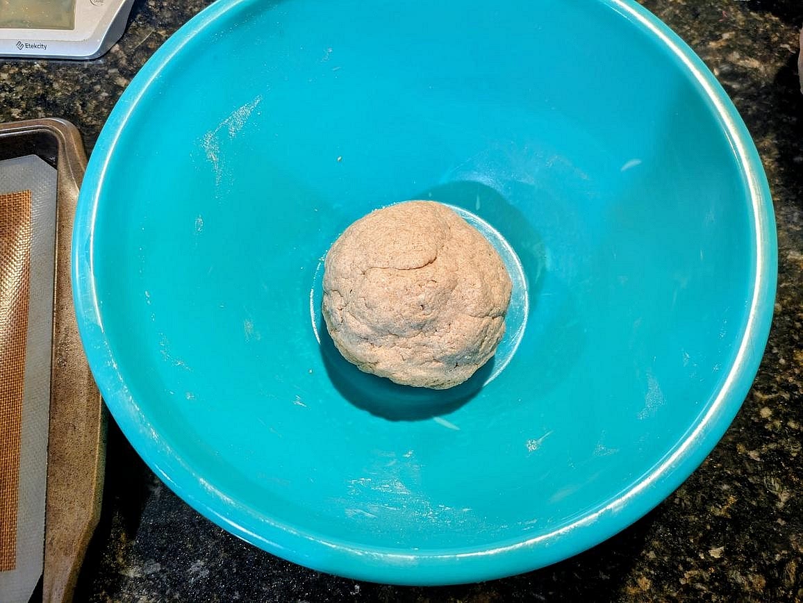 Add in the olive oil, and knead for about 2 minutes, until you have a semi-smooth and fully combined dough ball