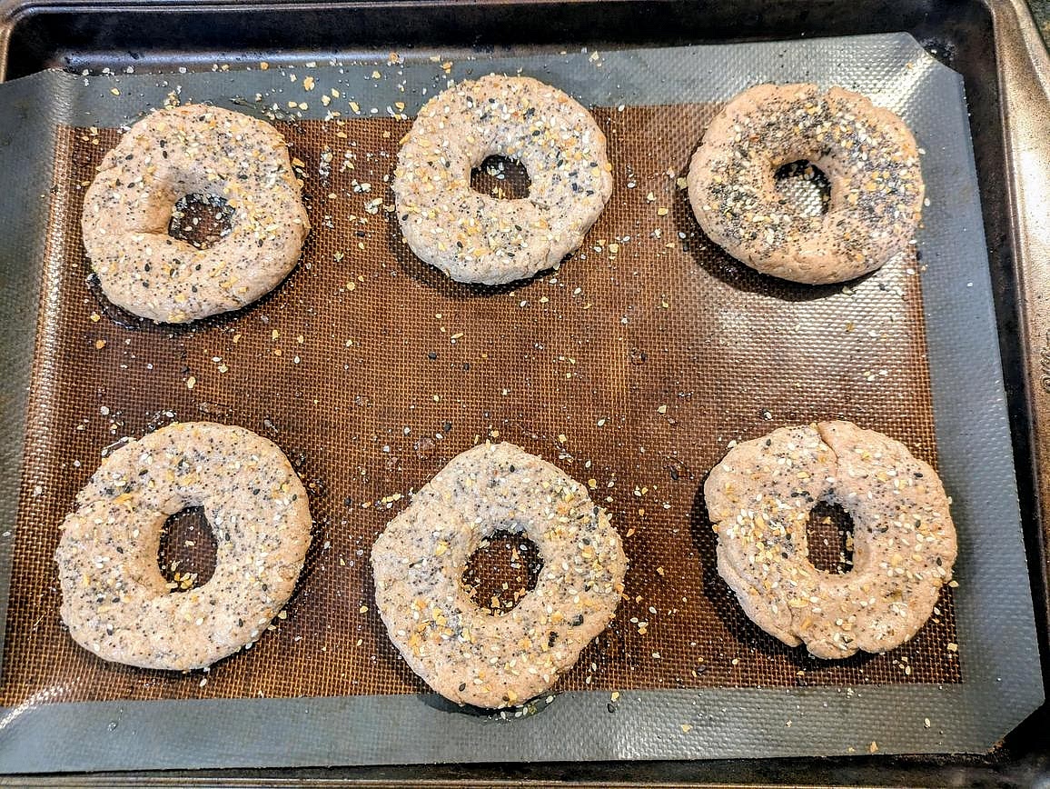 Optionally, brush the tops of the bagels with egg (or egg whites or water), and sprinkle the tops with everything bagel seasoning