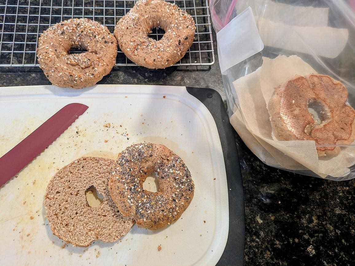 Cut each bagel in half, and add a piece of parchment paper between the halves