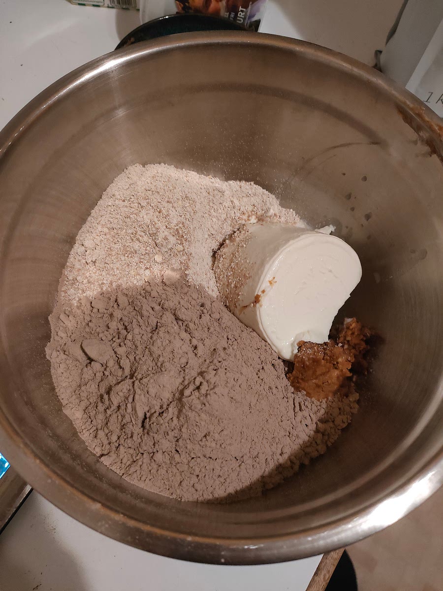 Put together mixed oats, peanut butter, protein, yogurt and milk in a bowl. Chocolate protein works best, but any taste works. Save a bit of yogurt for later.