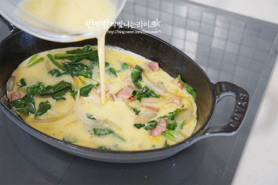 만들어둔 달걀물을 부어줍니다. 모짜렐라치즈와 방울토마토까지 모두 올려줍니다. 그대로 뚜껑을 덮고 찌듯이 익혀주는 방법도 있지만 고소한 풍미를 더해주기 위해 오븐 또는 에어프라이어로 구워줍니다. 오븐 190도 15분 구워주었습니다. 기기의 사양에 따라 온도와 시간은 조절해 주고, 속이 부드럽게 익을 정도면 되어요. 익은 정도를 확인하고 싶다면 나무 꼬치를 찔러보았을 때 묻어나지 않으면 됩니다. 오븐이나 에프로 조리하면 겉은 고소하면서 속은 부들부들 촉촉하게 치즈가 쭉 늘어난답니다. 버터에 재료를 한번 볶은 뒤 익혀주었기 때문에 고소한 풍미를 살릴 수 있으며 오믈렛 특유의 부들부들 촉촉한 식감이 별미입니다. 야채나 버섯을 다채롭게 넣어주면 든든하게 식사대용으로 먹기도 좋고요. 영상도 같이 담았어요. 노랗고 빨간 초록 색감부터 먹음직스러워 보이는 치즈오믈렛은 시금치가 들어가서 더욱 푸짐한데요. 버터에 재료를 볶아준 뒤 계란물과 치즈를 넣고 구워주면 간단하고 맛있게 완성되는 레시피랍니다. 시금치 프리타타 레시피로 부드럽고 촉촉한 맛을 즐겨보세요. 끄읕 !