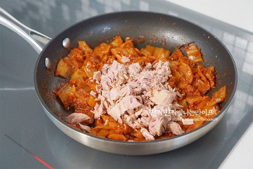 맛있게 익으면 참치를 넣어줍니다. 마지막에 넣으면 비린 맛도 잡아주고 부서지지 않아 더욱 풍성한 맛을 느낄 수 있습니다. 농도에 따라 캔참치 기름을 약간 넣어도 좋아요. 매콤하게 볶아지면 참기름과 통깨를 넣고 마무리해요. 마지막에 참기름을 넣어주면 고소한 풍미가 별미입니다. 갓 지은 밥 위에 올려먹음 그대로 한 그릇 뚝딱 비우는 맛이랍니다. 영상도 같이 담았어요. 신 김치의 새콤함을 잡아주기 위해 설탕을 약간 넣어주고, 달큰한 파기름에 고춧가루 양념을 더해볶으면 누구나 좋아하는 참치김치볶음 레시피 완성이에요. 간단한 기본이면서 별미 반찬이랍니다. 볶음김치 만드는법 매콤 고소함 가득 담아 맛있게 만들어 드세요^^ 끄읕 !