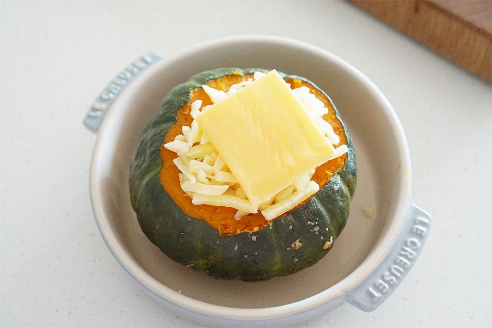 전자레인지용 용기에 올린 뒤 나머지 모짜렐라 치즈와 슬라이스치즈까지 모두 듬뿍 올려줍니다. 치즈가 듬뿍 들어가면 달콤한 맛과 고소하게 어울려요. 파슬리가루 약간 뿌린 뒤 전자레인지 5분 정도 돌려줍니다. 3분 이상 돌리면 반숙 상태로 입맛에 맞게 익힘 정도를 조절해 주세요. 치즈는 너무 오래 돌려도 수분이 날아가 단단하게 굳을 수 있습니다. 3~5분 사이로 치즈양을 조절하여 시간도 맞추어주면 됩니다. 치즈가 부드럽게 녹고 속의 계란이 먹기좋게 익으면 완성입니다. 이미 반이상 익어서 속재료가 잘 익으면 됩니다.