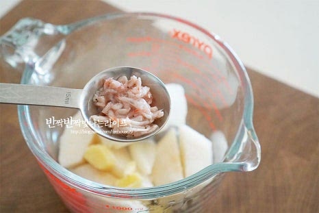 파김치 양념은 시원한 배가 들어가 은은한 단맛이 느껴지는데요. 배와 양파, 생강은 껍질을 벗겨 듬성듬성 잘라 넣고, 새우젓은 새우 건더기만, 매실액을 넣어줍니다. 기본 레시피에서 양은 1/4로 줄여 넣어주었는데 간에 따라 재료를 조절하여 주셔도 좋습니다. 재료를 모두 곱게 갈아줍니다. 따로 찹쌀 풀을 만들지 않고 배와 양파를 갈아 넣어 농도를 조절하는 것 또한 이영자 파김치의 팁이랍니다. 고춧가루 2/3와 절인 꽃게액젓도 따라 부어줍니다. 양념이 어우러지도록 잘 섞어줍니다. 간을 보면 적당히 매콤하면서 달짝하고 짭조름한 감칠맛이 조화로워요.