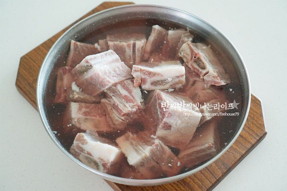 *황설탕 양을 줄이고 꿀을 더해주었고, 양념장 물 대신 배즙을 넣어주었어요. *기호에 따라 간을 가감해 줍니다. 하나, 만드는법에서 가장 중요한 것이 바로 핏물을 제거해 주는 것인데요. 뼈 사이의 핏물 제거를 잘 해주어야 깔끔하게 맛을 살릴 수 있답니다. 하루 전날 찬물에 담가 핏물을 제거하여 줍니다. 중간에 물을 갈아주면 시간을 줄일 수 있어요. 냄비에 재료가 잠길 정도로 물을 붓고 보글보글 끓으면 소고기를 넣어 약 5~7분 정도 익혀줍니다. 뼈 안의 핏물을 끓여서 굳혀주는 게 중요한데요. 그래야 요리 중 뼛속의 피가 흘러나오지 않아 간이 더 맛있게 어우러져요. 대략 5분 정도 삶아 뼈 부분을 눌러보았을 때 피가 나오지 않았어요. 사이사이 불순물을 흐르는 물에 씻어 제거한 뒤 체에 밭쳐 물기를 털어주고 냄비에 담아줍니다.