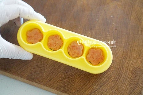 주먹밥 틀을 활용하여 동그랗게 모양을 내어주었는데요. 한 입 크기로 손으로 빚어주셔도 좋아요. 틀에 밥을 올리기 전에 스팸 꽃을 먼저 올려준 뒤 밥을 채워 넣어줍니다. 동그랗게 빚어지도록 고정해 줍니다. 틀에서 꺼내면 꽃 모양 스팸주먹밥 완성입니다.