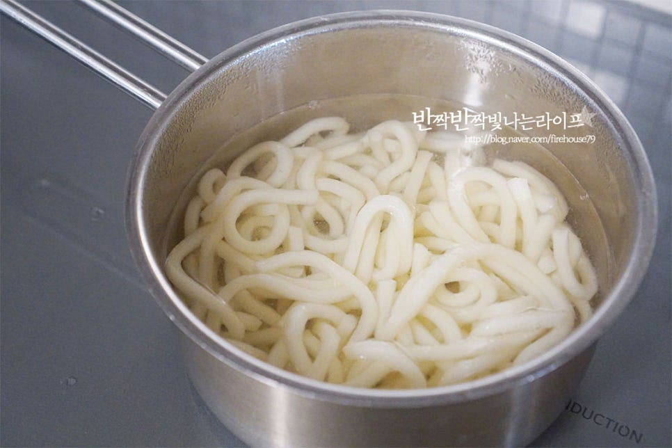 탱글하고 쫄깃한 면발의 우동면은 1인분씩 소분해되어 있던 것을 해동한 뒤 식감을 살리기 위해 가볍게 데쳐줍니다. 끓는 물에 면을 넣어줍니다. 살짝만 데친 뒤 찬물로 헹구어줍니다. 얼음 물에 살짝 담가도 면발의 식감이 탱탱해집니다.