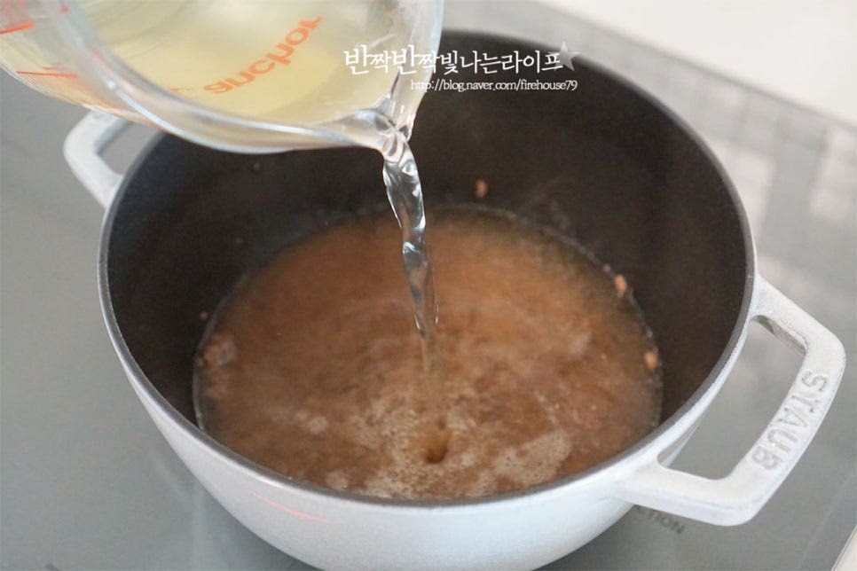 고기가 익으면 육수 800ml를 부어줍니다. 육수 양은 재료에 따라 가감하여 주세요. 국물이 바글바글 끓으면서 소고기의 진한 맛이 우러나요. 끓어오르면 떡과 만두를 넣어줍니다. 참치액 1/2 큰 술 넣어줍니다. 참치 액이 감칠맛을 더해준답니다~ 없다면 국간장이나 소금으로 대체하여 주세요. 떡국 떡은 익으면 위로 떠올라요. 떡이 떠오르도록 한소끔 끓여 익혀줍니다.