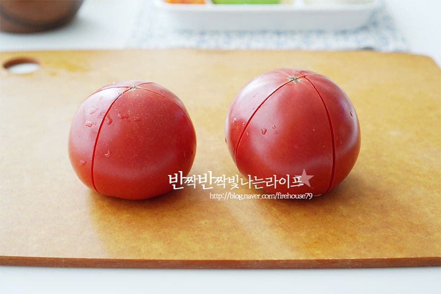 토마토 카레에 들어가는 주재료는 껍질을 벗겨 넣어줄 거예요. 꼭지를 제거한 뒤 깨끗하게 세척하여 십자 모양으로 칼집을 넣어주어요. 끓는 물에 살짝만 데쳐주면 십자 칼집 낸 부분부터 껍질이 쉽게 벗겨져요. 껍질을 벗긴 뒤 8등분으로 썰어주었어요.