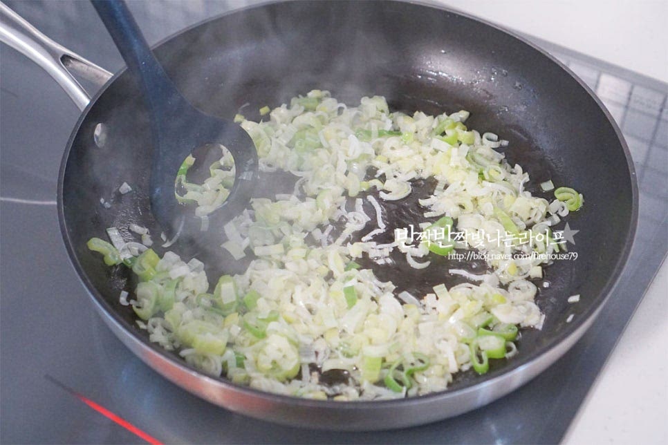 달군 팬에 식용유 2 큰 술, 참치 기름 2 큰 술을 넣고 다진 대파를 볶아 파 기름을 내어줍니다. 기름의 양은 조절해 주셔도 좋습니다. 대파가 나른하게 볶이도록 불을 조절해 파기름을 만들어 볶음밥을 만들면 향긋하고 고소한 풍미를 살릴 수 있습니다.