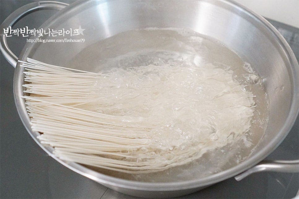 국수 면의 굵기는 좋아하는 것으로 준비해 주세요. 저는 소스와 어우러지는 소면 준비했습니다. 냄비에 물을 붓고 끓어오르면 면을 펼쳐 넣어줍니다. 면이 눌어붙지 않도록 젓가락으로 저어가며 삶다가 물이 끓어오르면 찬물을 반컵 정도 부어줍니다. 이 과정을 세 번 정도 반복하면 면발이 쫄깃하고 탱탱해집니다. 부드럽게 익으면 면을 건져내어줍니다. 찬물에 넣고 빨래를 빨듯이 비벼서 전분을 제거하여 헹구어줍니다. 그래야 밀가루 냄새가 나지 않고 면이 서로 붙지 않으며 탱글한 맛도 좋습니다. 국수는 삶는 것도 중요하지만 헹구어 씻는 것도 깔끔한 맛을 낼 수 있도록 해줍니다.