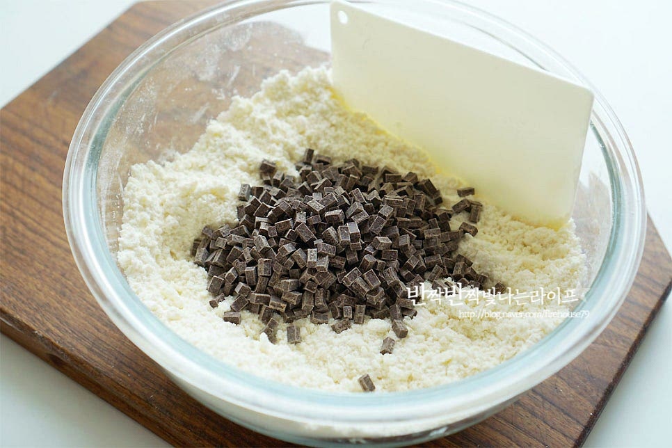 초코칩 100g을 넣고 가볍게 섞어주어요. 생크림 105g을 넣고 반죽을 골고루 섞어줍니다. 약간 되직한 느낌으로 반죽을 만들어주면 되는데 생크림은 양을 조절해가며 두 번 정도 나누어 넣어주셔도 됩니다. 되직한 것 같지만 섞어보면 뭉쳐진답니다~ 한 덩어리로 만들어졌어요. 그대로 휴지해주어도 되지만 식감을 위해 결을 살려주고 싶어 두세 번 접어 줄 것이랍니다. 반죽을 반으로 잘라 겹쳐 올려주는 과정을 두세 번 정도 반복하여 주었어요.