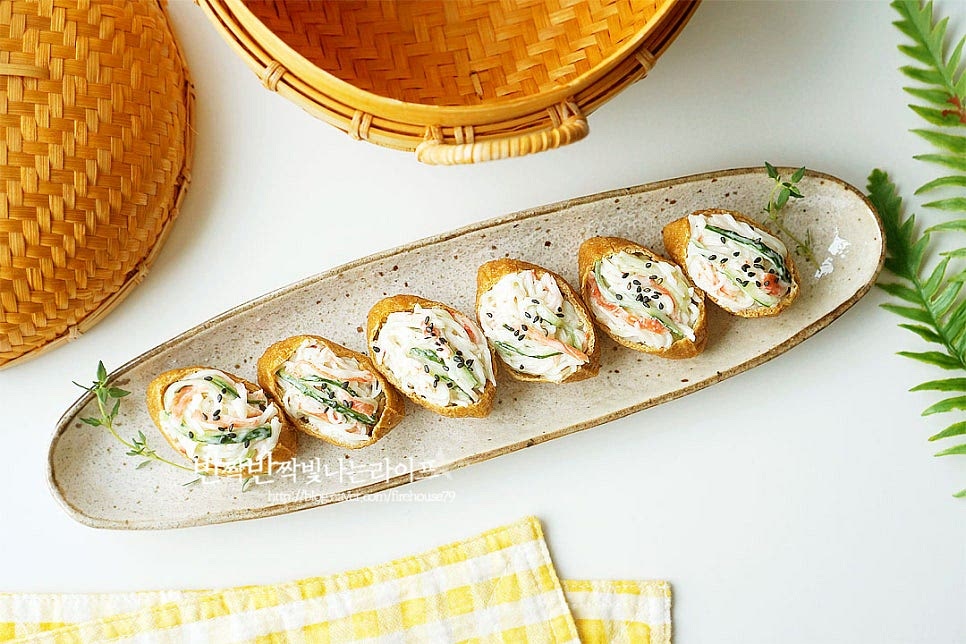 마지막으로 검은깨를 솔솔 뿌려 완성했습니다. 새콤달콤한 감칠맛과 고소한 풍미, 아삭한 식감까지 한 번에 맛볼 수 있는 유부초밥 레시피입니다. 크래미는 오이채와 함께 마요 소스에 버무리고 밥을 조금 적게 넣고 토핑으로 올려 만들면 맛과 식감이 좋습니다. 아이들이 먹을 땐 고추냉이는 생략하고 어른용에는 넣어주면 알싸하게 맛을 더해줍니다. 든든한 식사 메뉴로도 좋고 도시락에 넣어도 좋으니 맛있게 만들어드세요. 끄읕 !