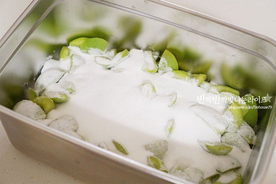 홍쌍리 매실장아찌는 2번으로 나누어 절임 숙성을 해주는데요. 과한 삼투압 작용이 일어나지 않도록 하여 과육이 쭈굴쭈굴하지않고 오독오독 식감을 있게 해준답니다. 손질한 과육의 1/2분량의 설탕을 넣어줍니다. 가볍게 버무린 뒤 하루 숙성해 줍니다. 뚜껑을 덮고 통풍이 잘 되는 서늘한 곳에 둡니다. 중간에 따로 젓지 않고 설탕에 버무린 그대로 하루 두면 물이 많이 생겨있습니다.