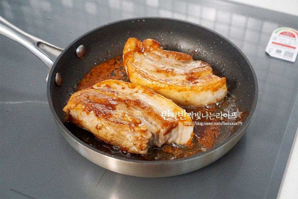 달군 팬에 식용유 4~5 큰 술 넉넉히 두르고 흑설탕 2 큰 술을 넣고 녹여줍니다. 설탕이 타지 않게 중불로 녹여준 뒤 삶은 삼겹살을 올려 노릇노릇 코팅되는 느낌을 구워줍니다. 앞뒤로 굽다 보면 녹은 흑설탕이 표면에 코팅되어 노릇노릇해진답니다~ 구운 고기는 2cm 정도의 두께로 썰어줍니다.