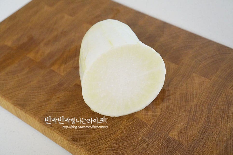 무는 깨끗하게 세척한 뒤 껍질을 벗겨 준비했습니다. 겉이 깨끗한 편이라면 야채 솔로 문질러씻고 그대로 요리해도 됩니다. 대략 1/2개 분량의 무생채를 만들면 꽤 양이 넉넉하게 만들어지기 때문에 김치 대신 반찬으로 개운하게 먹기도 좋고 기름기 있는 음식에 느끼함을 잡아주는 곁들임이나 밥에 계란과 넣고 비빔밥을 만들어도 별미에요. 절이지 않고 만드는 생채이기 때문에 간이 밸 수 있도록 곱게 채를 썰어주는 기본 손질 과정도 중요합니다. 채를 썰 때는 손이 다치지 않도록 둥근 부분을 조금 잘라내어 바닥면에 평평하게 고정하여 썰거나 채칼을 이용해도 좋습니다. 칼을 사용할 때는 손 조심해 주세요. 일정한 두께로 곱게 채를 썰어줍니다. 대략 0.2~0.3cm 두께로 잘라주었어요.