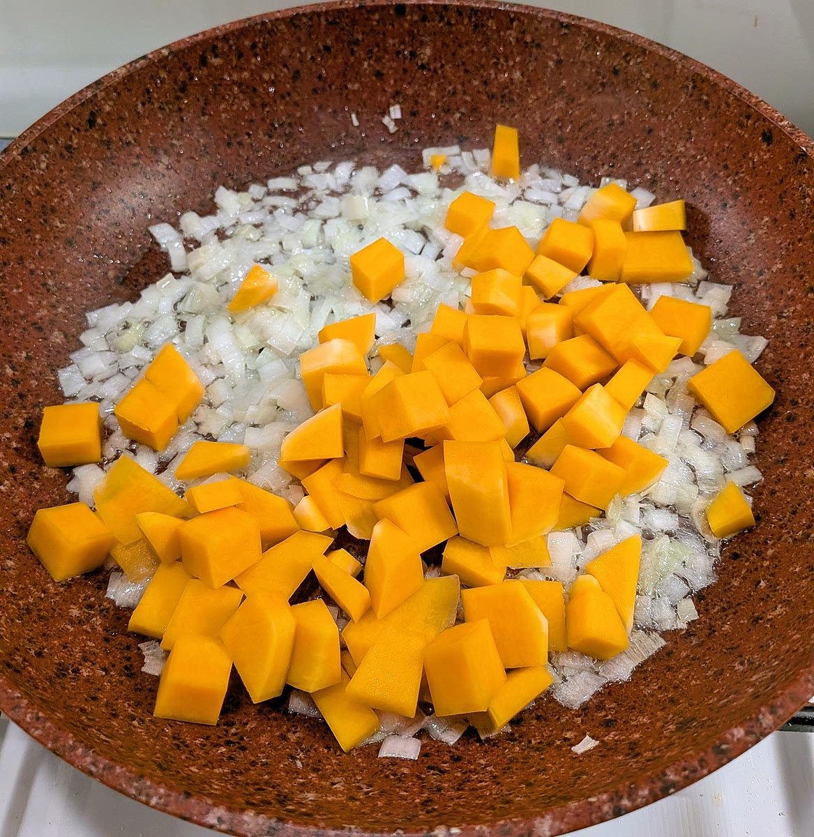 Add the cubed butternut squash to the pan, season with salt to taste and toss the contents to mix them together.