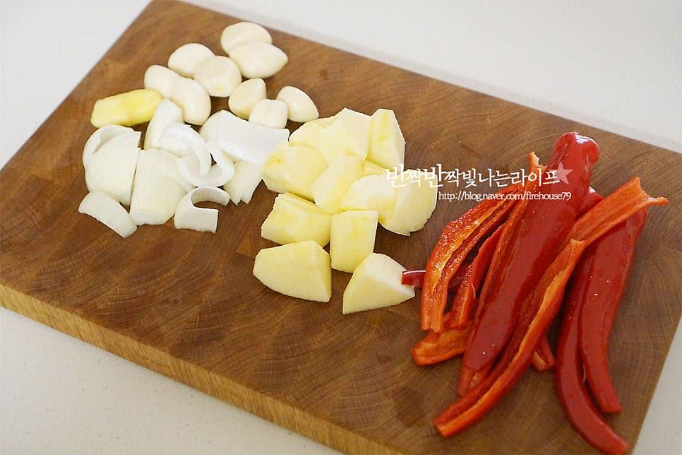 양념은 믹서기에 갈아서 넣는 것과 바로 넣는 것을 따로 준비합니다. 마늘과 생강은 깐 것을 준비하고 양파와 사과는 갈기 좋도록 깍둑썰기 합니다. 고춧가루보다 홍고추를 넉넉하게 갈아 넣으면 텁텁하지 않고 깔끔하게 맛을 낼 수 있어요. 반으로 잘라 씨를 제거한 뒤 갈아줍니다. 홍고추와 청양고추도 큼직하게 잘라주세요. 블렌더에 손질한 생강, 마늘 양파, 고추, 사과를 넣고 밥 100g, 물 1컵을 넣어줍니다. 찹쌀풀을 만들어 넣깆도 하는데 알토란 열무김치는 밥을 넣어 풋내를 잡고 농도를 맞추어줍니다. 잡곡밥을 넣어도 좋다고 합니다. 한데 넣고 부드럽게 갈아줍니다.