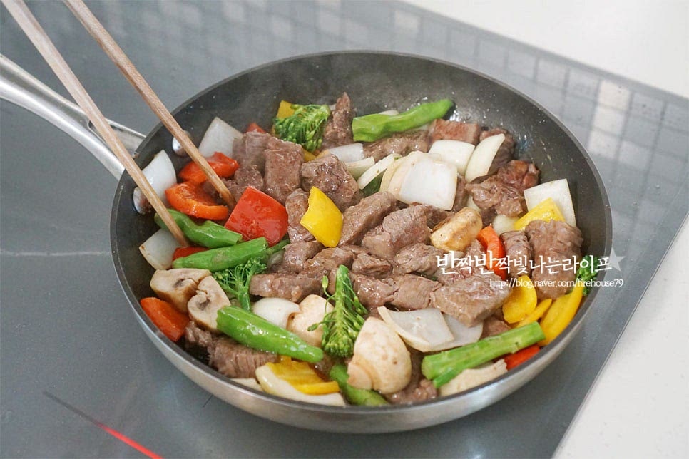 노릇해지면 버섯, 양파, 파프리카 브로콜리, 꽈리고추 모두 넣어줍니다. 채소가 아삭하게 익으면 팬의 한쪽으로 밀어두고 만들어둔 소스를 부어줍니다. 미리 만들어두면 바로 부어 조리할 수 있어요. 농도를 조절하기 위해 물 90ml도 부어주는데요. 야채에서도 수분이 나오기 때문에 농도를 보아가며 조절해 넣어줍니다. 저는 양을 반으로 줄여 넣었습니다. 서로 섞이도록 골고루 볶아줍니다. 센 불로 졸이듯이 볶아 완성해요. 간을 보고 신맛을 살리고 싶다면 케첩을, 고소하게 먹고 싶다면 버터를 더해 완성해 주면 됩니다. 색색의 재료를 푸짐하게 담은 뒤 방울토마토와 파슬리가루를 더해 마무리했어요. 허브잎을 곁들이면 더욱 먹음직스럽습니다. 영상도 같이 담았어요. 먹을수록 고소하고 새콤달콤한 소스 맛이 풍부하게 느껴지면서 질리지 않고 손이 가는 맛이에요. 푸짐함은 물론 간단한 레시피로 근사한 요리를 맛볼 수 있답니다. 안심 찹스테이크라 부드럽기도 하고요. 소고기 찹스테이크 만들기 맛있고 근사한 요리를 즐겨보세요. 끄읕 !