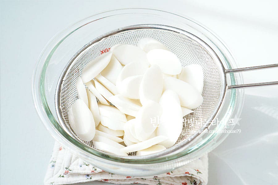 떡을 준비해요. 가래떡을 썰면서 생기는 가루가 떡에 붙어있기 때문에 물에 헹구어 준 뒤 체에 밭쳐 물기를 제거해 줍니다. 냉동 떡이라면 물에 조금 담갔다 넣어주세요.