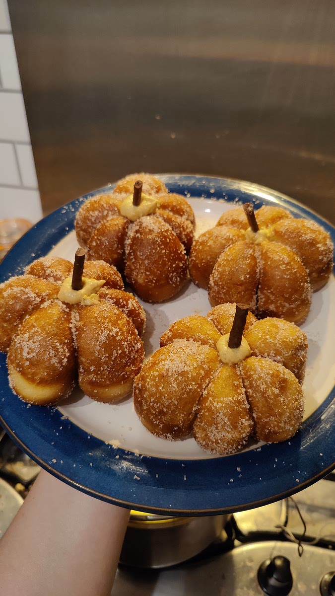 Finally, stick 1/3rd of a matchstick into each donut hole to look like a stalk, and enjoy your mini pumpkin donuts!