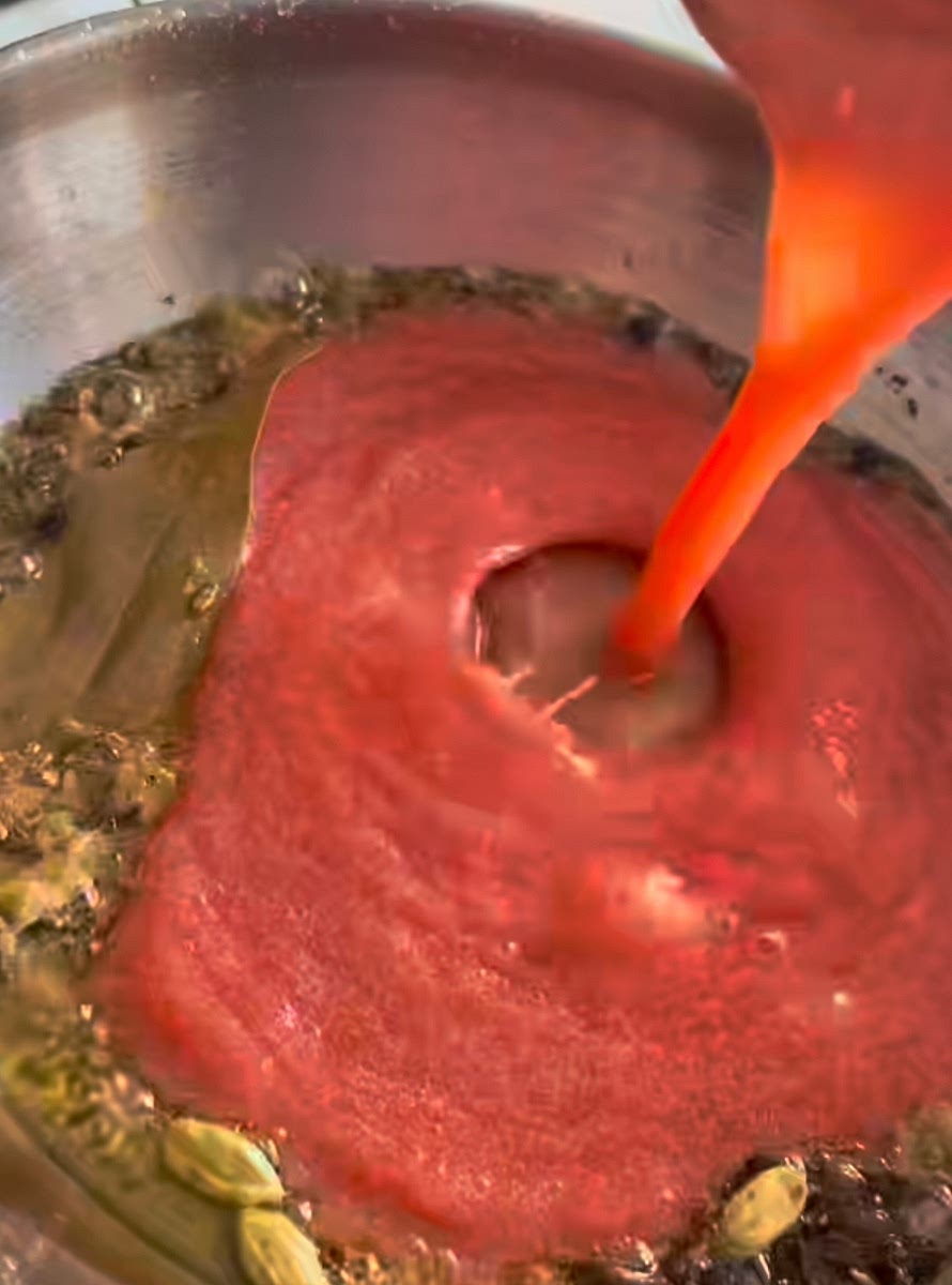 •	Add tomato puree and cook until oil separates.