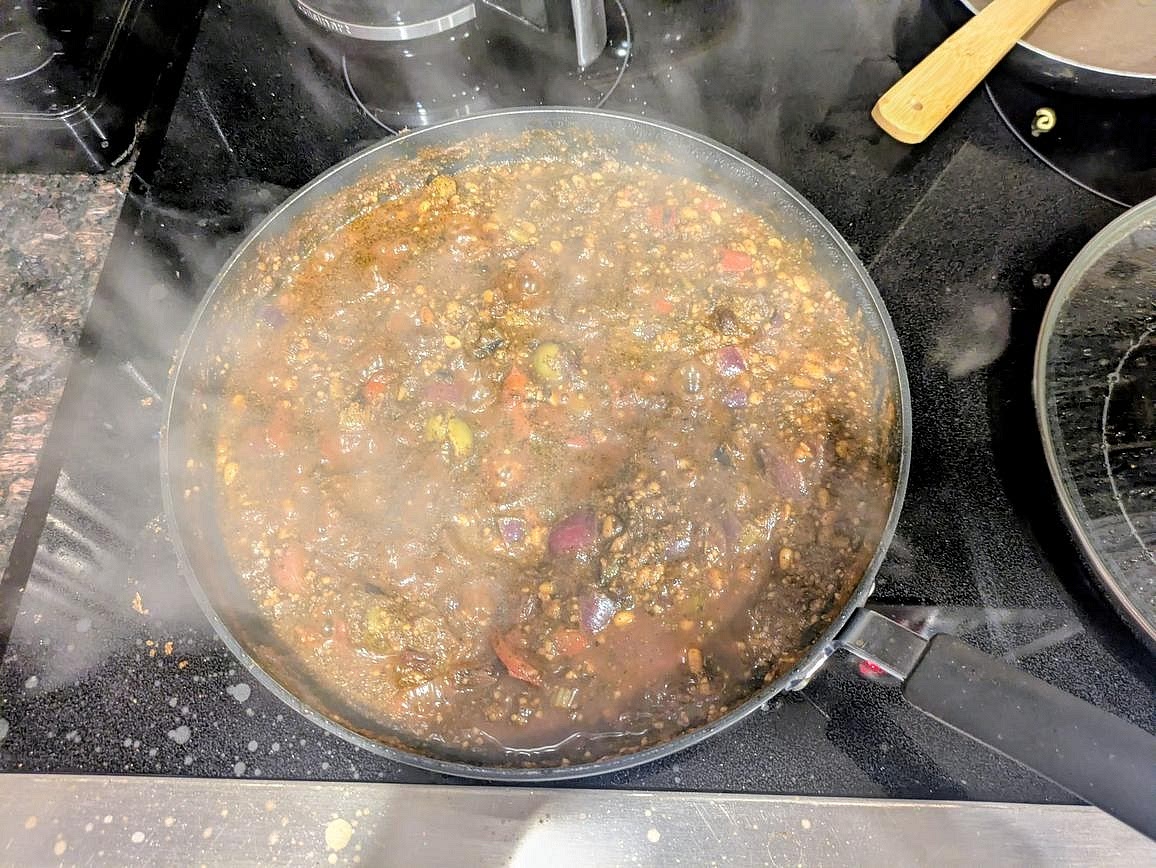 Add the pine nuts and the sauce ingredients to the pan with the veggies. Reduce heat to medium low, cover, and simmer until the eggplant is done roasting