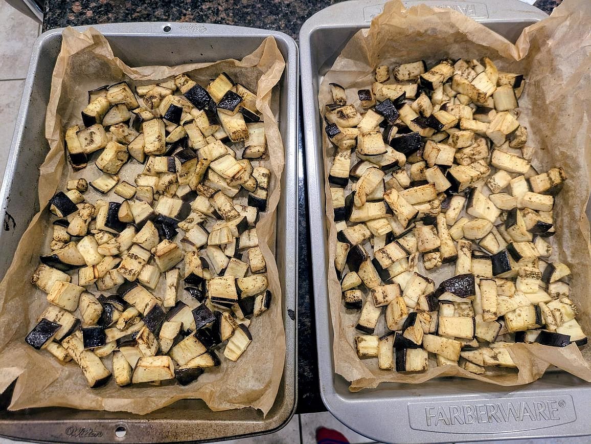 Preheat your oven to 400F, and line a large cookie sheet with parchment paper. Toss the drained eggplant with oil and pepper. Roast at 400F for about 30 minutes, or until browned and soft