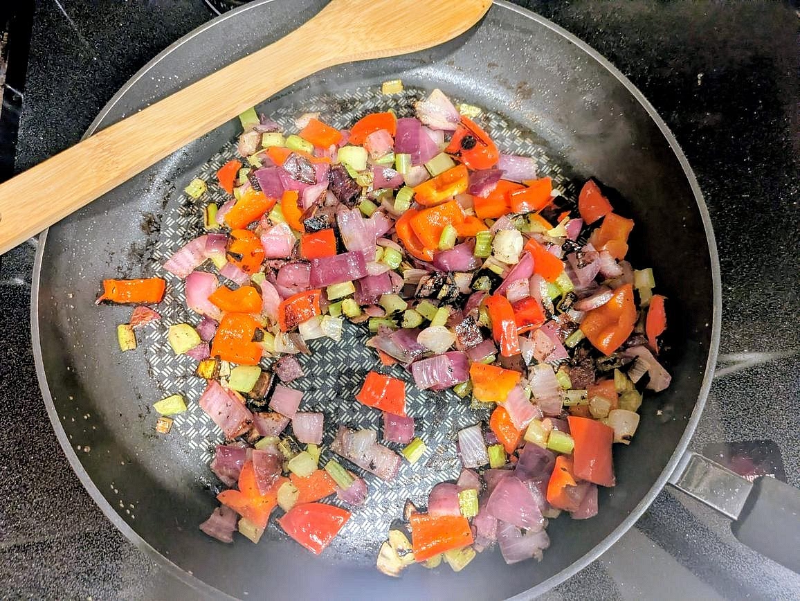 Meanwhile, heat a large pan over medium heat. Cut your onion and pepper into a medium dice and finely dice the celery. Add the veggies to the pan with oil and salt. Cover and cook until softened and lightly browned, about 8 minutes