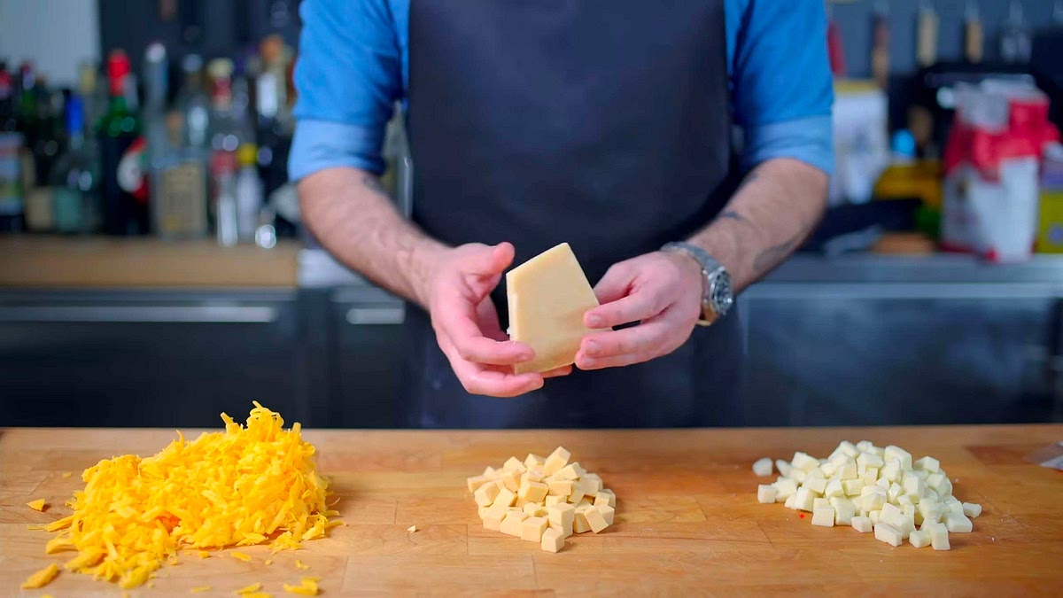 Shred sharp cheddar, cube mozzarella, and cube smoked gouda