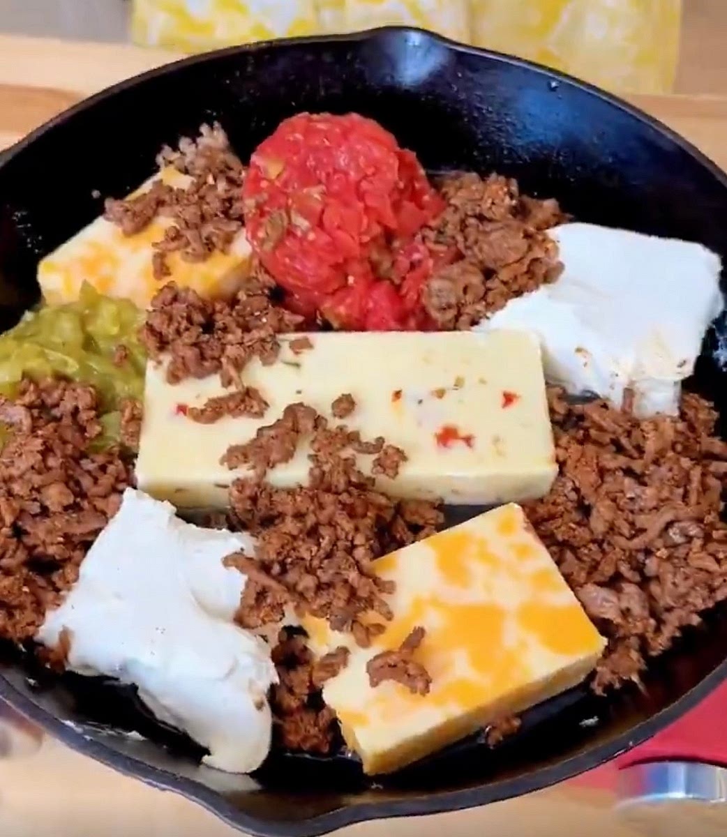 Spread out all ingredients evenly in an oven-safe skillet, over the top of the milk, pour milk on top.