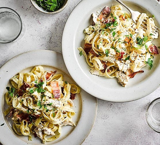 Creamy Chicken & Bacon Pasta Bake Serves: 4–6 Prep Time: 15 mins Cook Time: 25–30 mins --- Ingredients Main 1 pack bacon, chopped 2–3 chicken breasts, chopped 2 large handfuls spinach 1 punnet baby tomatoes, chopped 300–400g penne pasta Sauce 300ml double cream 1 cup grated Parmesan (plus extra for topping) 1–2 tsp Italian herbs ½–1 tsp garlic salt --- Instructions 1. Cook the Pasta 1. Bring a large pan of salted water to a boil. 2. Add the penne and cook until al dente. 3. Drain and set aside. --- 2. Make the Chicken & Bacon Mix 1. In a large pan, fry the chopped bacon until it starts to crisp. 2. Add the chopped chicken and cook until fully done. 3. Add the chopped tomatoes and spinach. 4. Cook until the tomatoes soften and the spinach wilts. 5. Take off the heat and set aside. --- 3. Make the Creamy Sauce 1. Pour the double cream into a small saucepan. 2. Add the grated Parmesan, Italian herbs, and garlic salt. 3. Stir on low heat until the cheese melts and the sauce thickens slightly. 4. Remove from heat. --- 4. Layer the Bake 1. Preheat oven to 180°C (350°F). 2. In a baking dish, add a layer of cooked pasta. 3. Add a layer of the chicken/bacon/spinach/tomato mix. 4. Spoon over some of the creamy sauce. 5. Repeat the layers until everything is used. 6. Finish with a final drizzle of sauce and plenty of Parmesan on top. --- 5. Bake 1. Place in the oven for 15–20 minutes, until golden and bubbling. 2. Remove from the oven and rest for a few minutes before serving. --- Enjoy! Creamy, cheesy, savoury and so comforting — perfect for a cosy dinner or a meal-prep favourite.