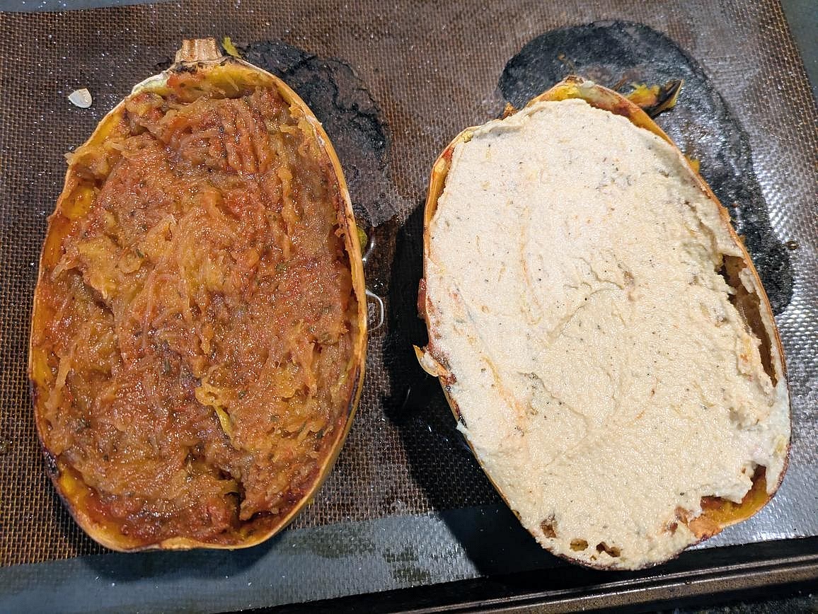 Fluff the squash with a fork, keeping it in the skin and the skin intact. Add half your sauce to each half of the squash, and mix until fully combined. Top each half with half the cheese