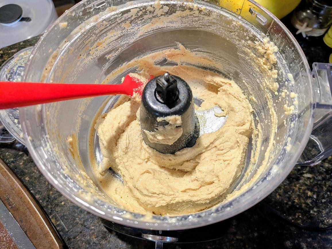 Add all ingredients to a food processor (including the soaking liquid), and blend until smooth, about 5 minutes with occasional scraping of the sides