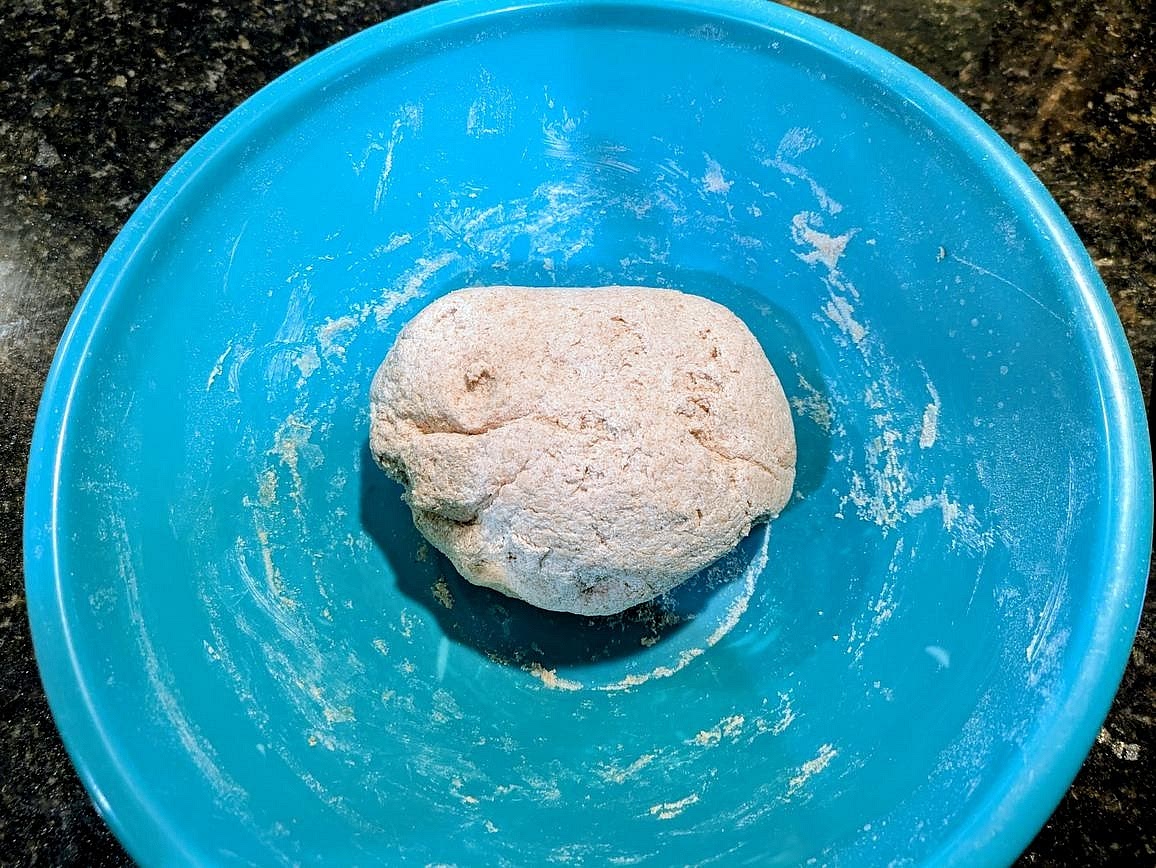 Add in the flour, and mix with a silicone spatula until you can't incorporate any more with the spatula, and then finish kneading together with your hands. You should have a slightly sticky dough with the flour fully incorporated