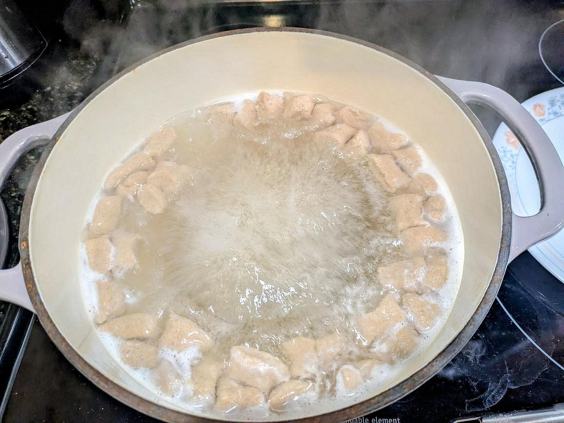 Bring a pot of water to a boil. Place in the gnocchi, and boil for about 3 minutes, or until they float to the top. Remove with a strainer, and serve with any sauce you desire