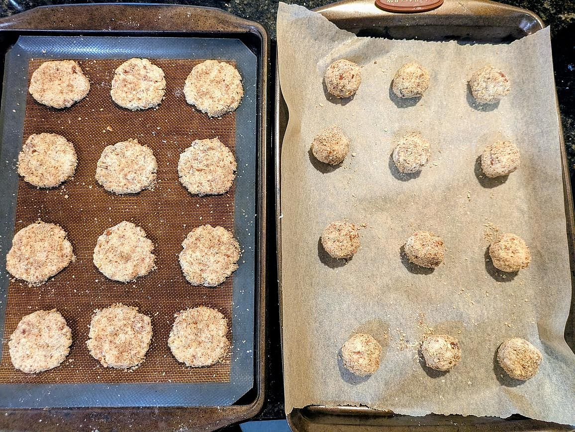Scoop your dough into 24 cookies, about 2 tbsp (31 g) in size. Lightly roll in the pecan meal, and add to the cookie sheet. Flatten down to about 1/4" thick