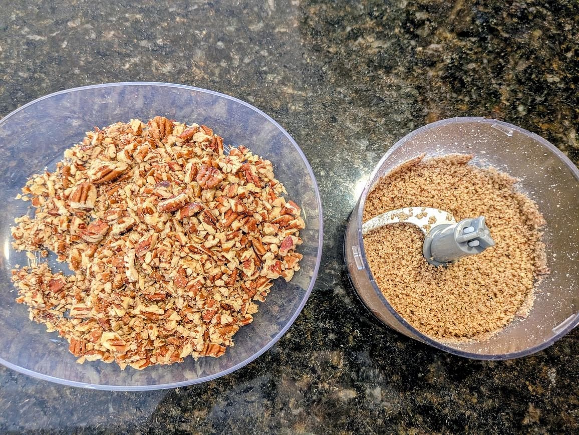 Using a food processor, pulse 1 cup (128 g) pecans a few times, until roughly chopped, and set aside. With the remaining 1/2 cup (64 g), blend until you have a fine crumb. The former (roughly chopped pecans) will be folded into the cookie dough, whereas the latter (pecan meal) will be used for rolling prior to baking