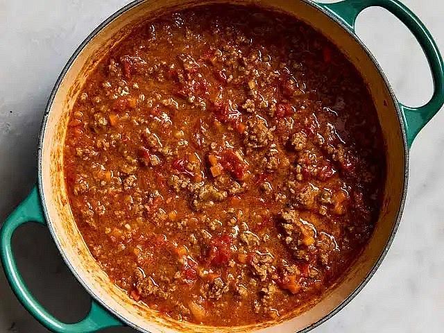 Instructions 1. Heat a generous drizzle of olive oil in a large pan over medium–high heat. 2. Add the minced meat and cook until well browned, stirring occasionally. 3. Season with salt and black pepper. 4. Add the onions, carrots, and celery. Cook until softened and most moisture has evaporated. 5. Add the garlic and cook for 30 seconds until fragrant. 6. Pour in the red wine and simmer for 2–3 minutes until the alcohol cooks off. 7. Add Worcestershire sauce and stir well. 8. Stir in the tomato paste until fully combined. 9. Add the canned tomatoes, water, and stock cubes. Stir until dissolved. 10. Add chilli if using. 11. Reduce heat to low and simmer gently for 1–2 hours, stirring occasionally. 12. Cook pasta in well-salted water, drain, and serve topped with the bolognese sauce. 13. Finish with freshly grated Parmigiano Reggiano. Notes Simmering longer deepens flavor. Grated vegetables give a smooth, rich texture. Add a splash of pasta water when mixing pasta and sauce for perfect coating. Freezes well for up to 3 months. Nutrition (per serving, approx., assuming 4 servings) Calories: 450 kcal Protein: 28 g Fat: 20 g Carbohydrates: 35 g Fiber: 5 g Tags Bolognese, Italian, Pasta, Beef, Dinner, Comfort Food, Freezer Meal, Slow Cook