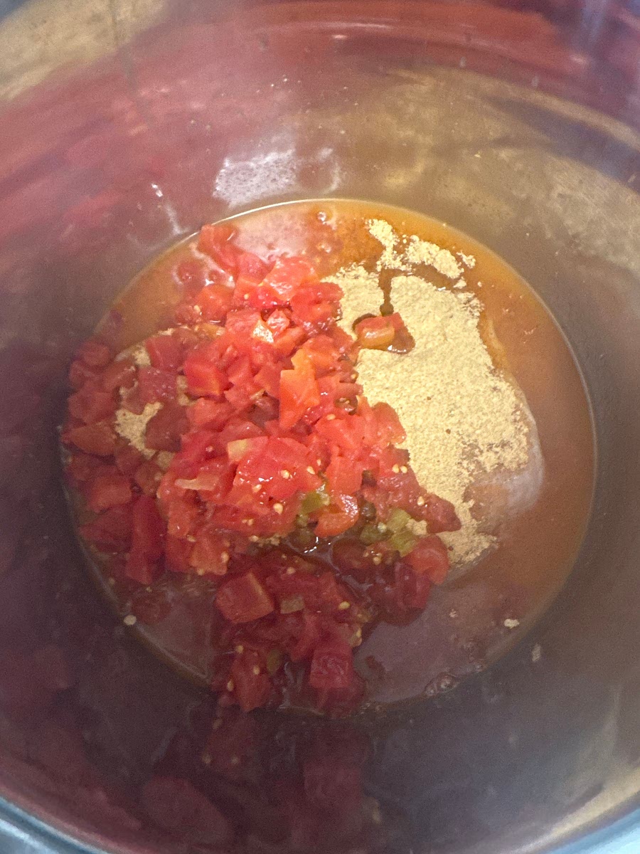 Pressure Cook the Chicken
1. Place the frozen/refrigerated chicken breasts in the Instant Pot.
2. Pour in the chicken broth, 1/2 cup of enchilada sauce, the entire can of Rotel, and the taco seasoning.
3. Pressure Cook (High) and set the timer for 15 minutes.
4. When the timer beeps, allow a 10-minute natural pressure release, then manually vent any remaining steam.