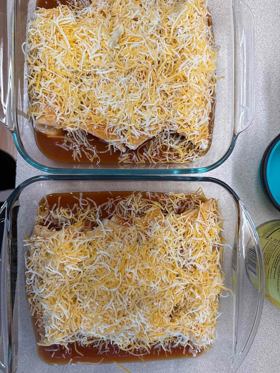 Assemble and Bake
1. Preheat your oven to 375°F. 2. Lightly coat the bottom of a 9x13 baking dish with a thin layer of enchilada sauce.
3. Warm your tortillas in the microwave for 30 seconds to make them pliable.
4. Place a generous scoop of the chicken mixture into each tortilla, roll tightly, and place them seam-side down in the dish.
5. Pour the remaining enchilada sauce over the top and sprinkle with the remaining 1.5 cups of shredded cheese.
6. Bake for 15 minutes or until the cheese is melted and the edges of the tortillas are slightly crisp.