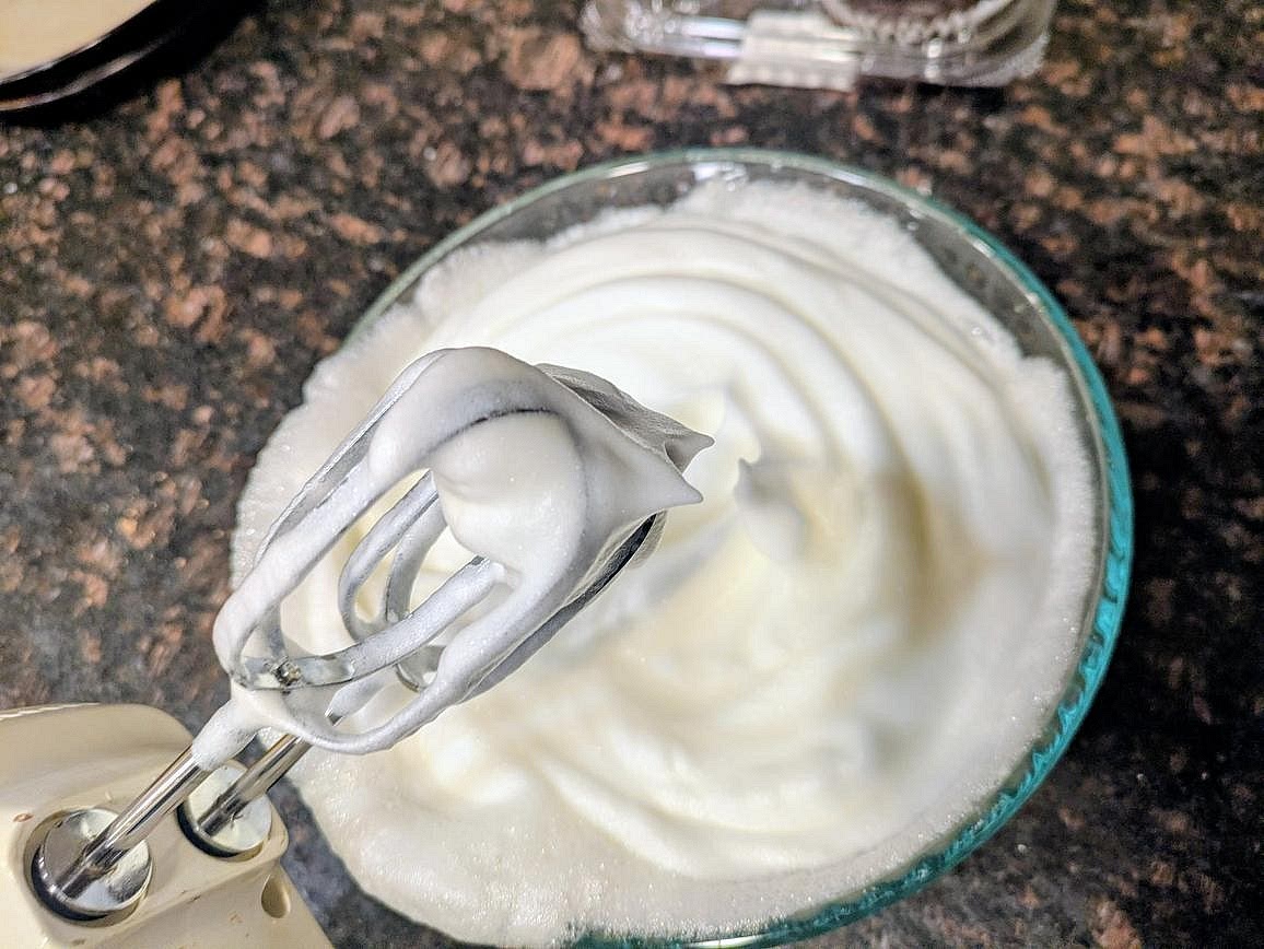 In a large glass or metal bowl, whip your egg whites on high speed with a hand mixer for about 5 minutes, or until you have stiff peaks