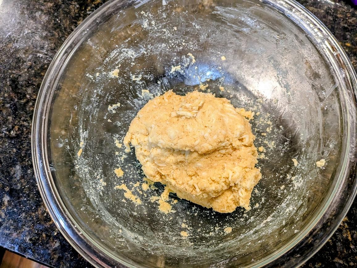 Add the almond flour bowl and a beaten egg to the bowl with the melted cheese. Mix with a silicone spatula to incorporate, and knead with your hands until combined. The dough should be slightly sticky