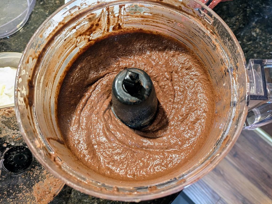 Drain and rinse a can of chickpeas. Add all ingredients to a food processor, and blend until smooth. Divide into 4 servings