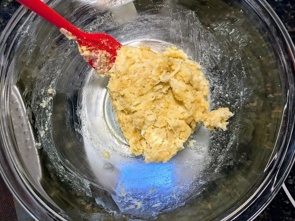 Add in the almond flour, and mix in with the spatula. Crack in the egg, mix with the spatula, then knead together to make a combined and slightly sticky dough